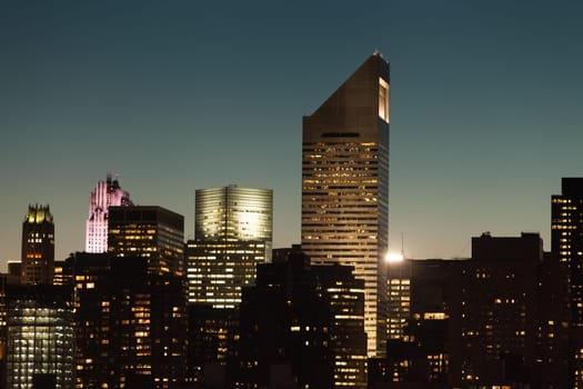 Manhattan cityscape detail with modern skyscrapers and business buildings during twilight in New York City, USA.