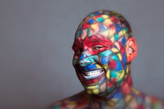 Malicious villain smiling portrait, colorful face art with tilt shift and motion blur effect.