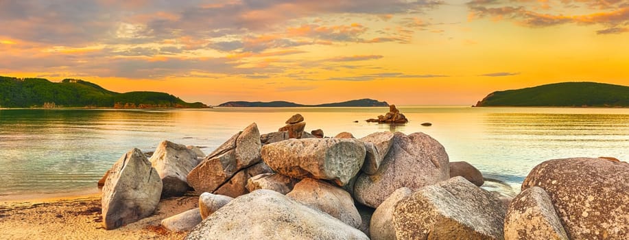 Amazing landscape at sunset. Stones on the foreground. Panorama