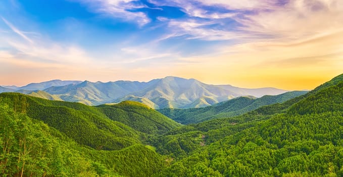 Panoramic view of a mountain valley at sunset time. Panorama