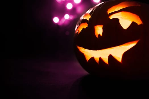 scary halloween pumpkins on a purple light background.