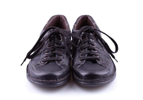 Black leather men's shoes on white background.