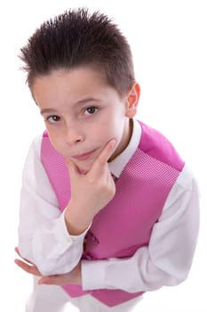 Young boy holding his chin and looking at camera celebrating his First Holy Communion on a white background. High angle shot.