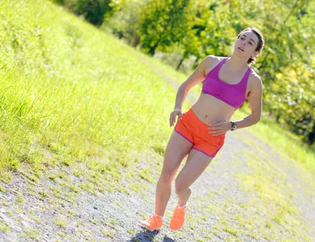 Beautiful  young athletic woman running in countryside