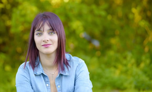 portrait of a young woman with green eyes and red hairs, outdoors