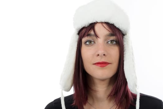 portrait of a beautiful young woman with a winter hat isolated on white background