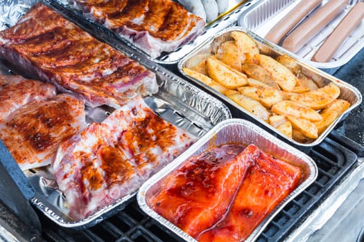 Various delicious grilled meat and sausage on a grill..