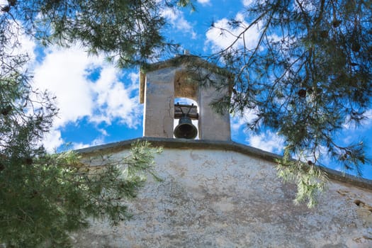 Bell in Spanish style against a blue sky..