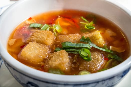 Bowl on a table with a traditional Chinese soup..