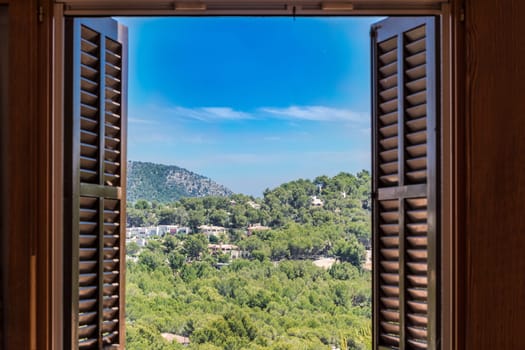Landscape houses and mountains seen through the window..