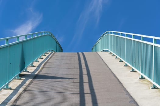Pedestrian bridge made of steel in arch artery over the river Ruhr in Muelheim,Germany..