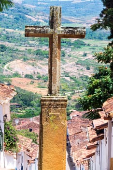 Stone cross with colonial town of Barichara, Colombia below