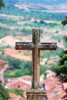 View of a stone cross outside of the Santa Barbara church in Barichara, Colombia