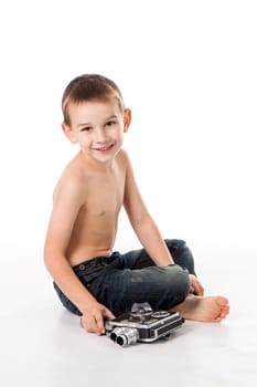 Caucasian boy plays to shoot at the old camera.