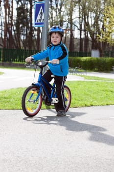 child on a bicycle at asphalt road on traffic playground