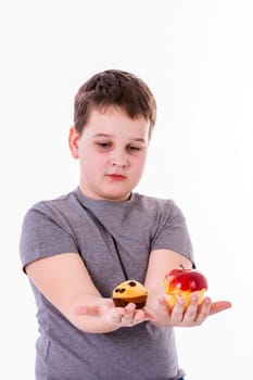 little boy with food isolated on white background - apple or a muffin