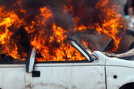 burning and then extinguish an old white car - Exercise firefighters