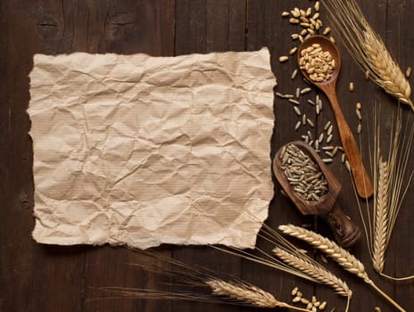 Wheat and spelt on an old wooden background