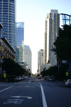 Traffic on Kettner Boulevard in San Diego with various buildings and the Santa Fe train station.