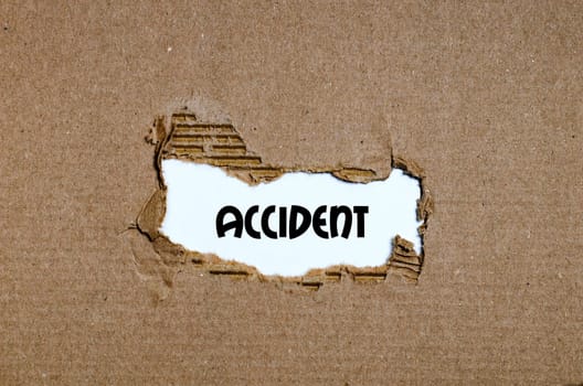 The word accident appearing behind torn paper