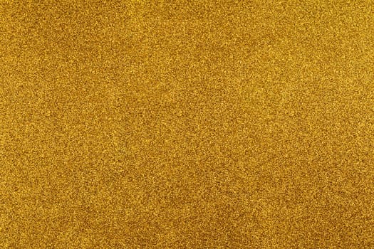 Horizontal glittery gold colored background texture