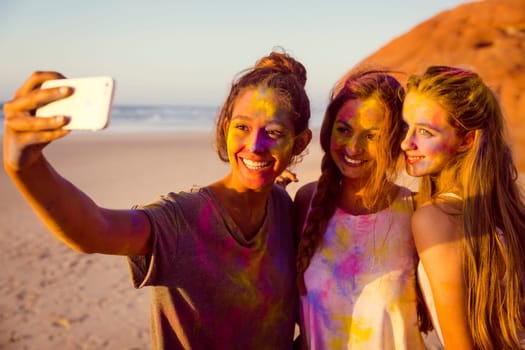 Teenagers making a selfie after playing with colored powder