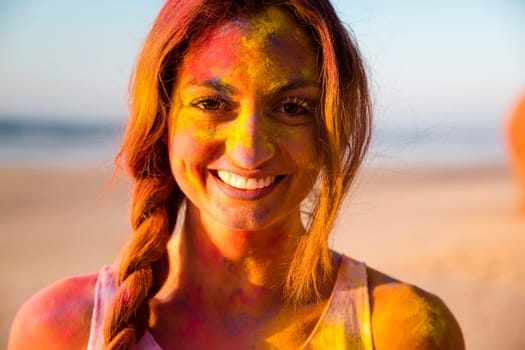 Portrait of a beautiful girl full of colored powder all over the body