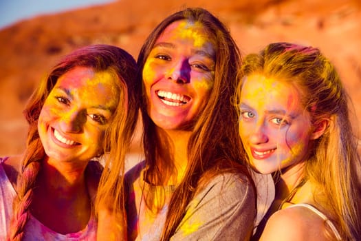 Best friends full of colored powder all over the body