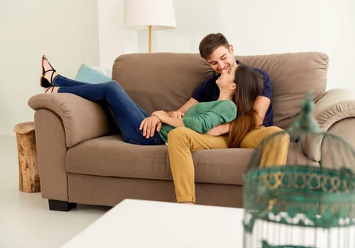 Young couple on the sofa drinking coffee