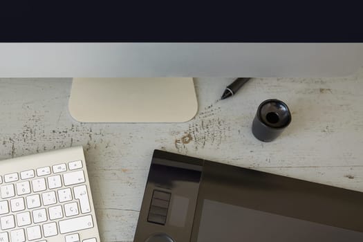 Top View of Computer, Keyboard and Graphic Tablet on Wooden Table.