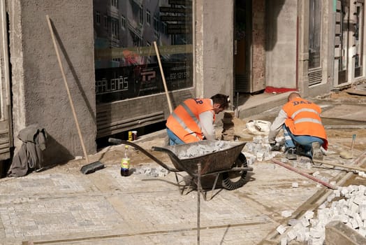 Construction workers renew a cobblestone footpath in downtown Prague