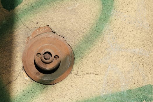 old rusted bell button at the entrance of a house