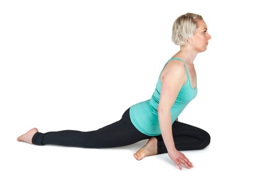 Young woman on a white background in half a spagath. The right leg stretched backwards  the left foot under the center of the body.