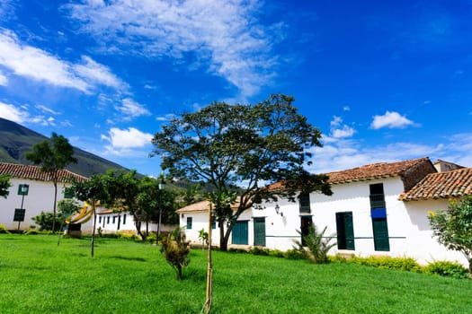 Lush green park and white colonial architecture in Villa de Leyva, Colombia