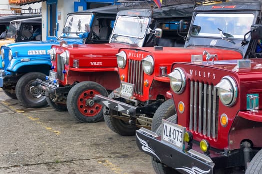 SALENTO, COLOMBIA - JUNE 6: Row of Willys jeeps in the plaza of Salento, Colombia waiting to take tourists to Cocora Valley on June 6, 2016