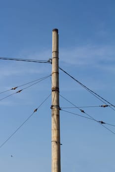 Vertical photo of concrete pillar anchored with steel cables