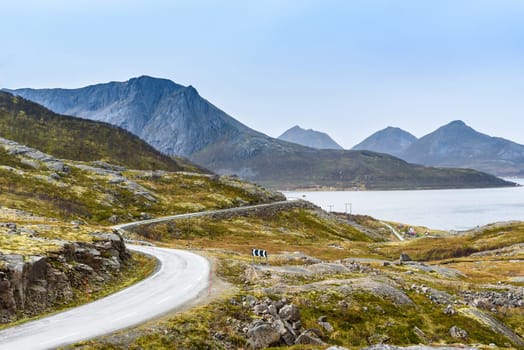 Turning mountain asphalt road with sky and sea