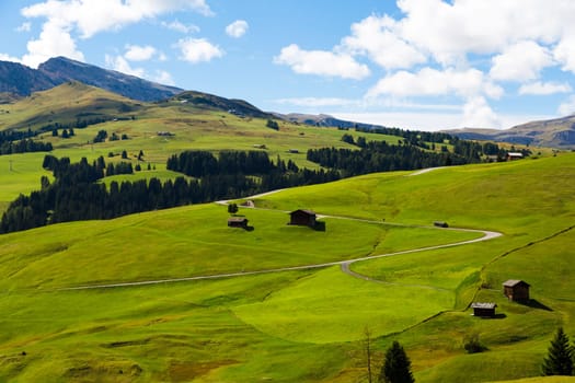 panoramic view of the Seiser Alm in a sunny day with blue sky and clouds