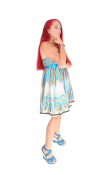 A portrait image of a woman in her thirties, holding her hand under her.chin with long red hair, isolated for white background..