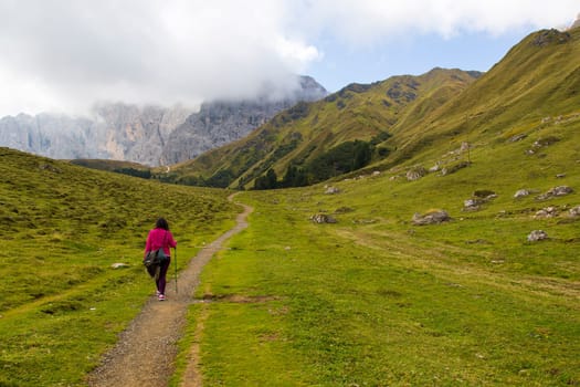 View of a hiking trail on Seiser Alm with mountain range on the background