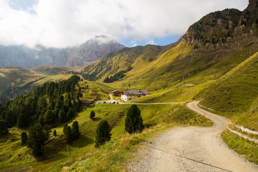 View of a hiking trail on Seiser Alm and a refuge  on the background