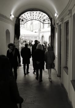 Tourists in the Old Town of Prague passing through to a backyard