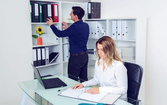 young businessman and businesswoman working together in the office