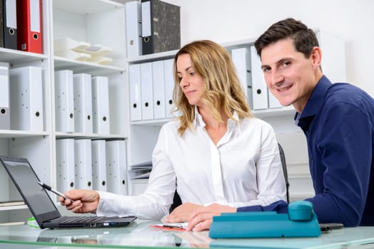 young businessman and businesswoman working together in the office
