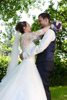 Happy bridal couple embraces each other