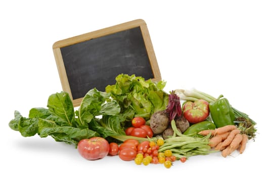 assortment of seasonal vegetables with  blackboard, on white