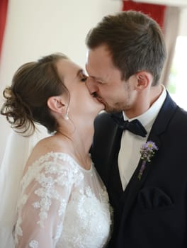 Bride and groom kiss after the wedding ceremony in the registry office
