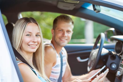 Young happy people enjoying a roadtrip in the car