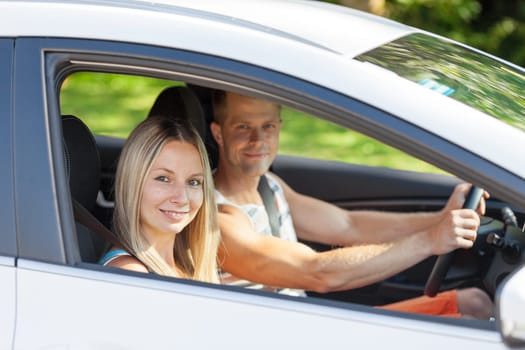 Young happy people enjoying a roadtrip in the car