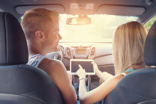Young happy people enjoying a roadtrip in the car